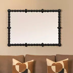 Specchio con cornice in legno con perline e pioli, nero, di Storied Home Chic